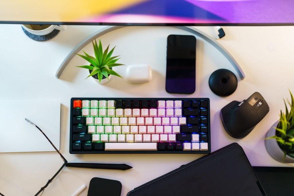 A neat desk setup with keyboard, smartphone, and plants, ideal for work-from-home productivity.